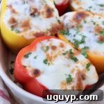 Stuffed peppers topped with melted mozzarella cheese in a casserole dish, ready to be served as a delicious meal.
