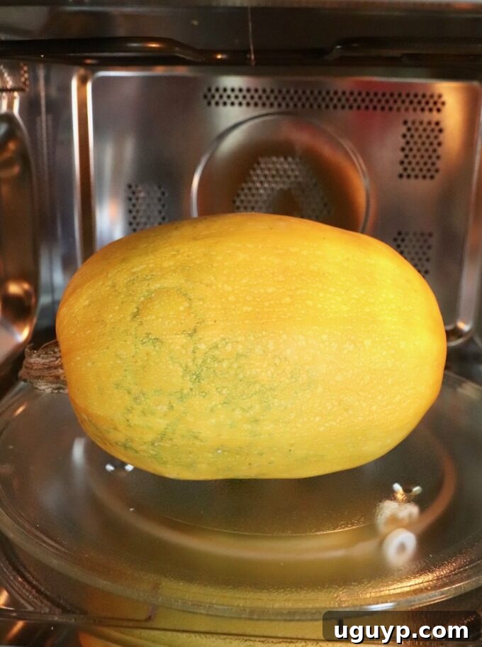 A whole spaghetti squash placed on a microwave-safe plate inside a microwave oven.