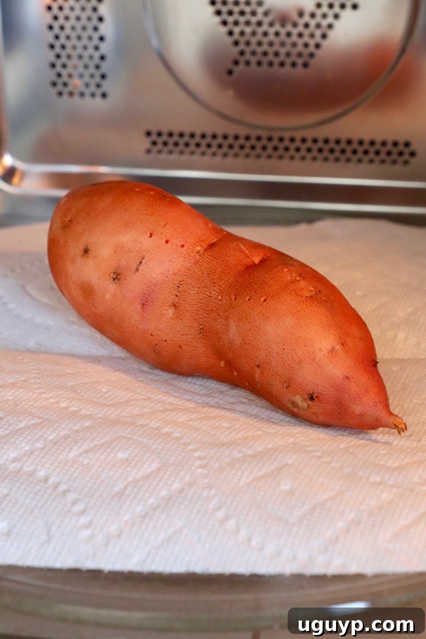 Sweet potato prepared for microwave cooking on a paper towel