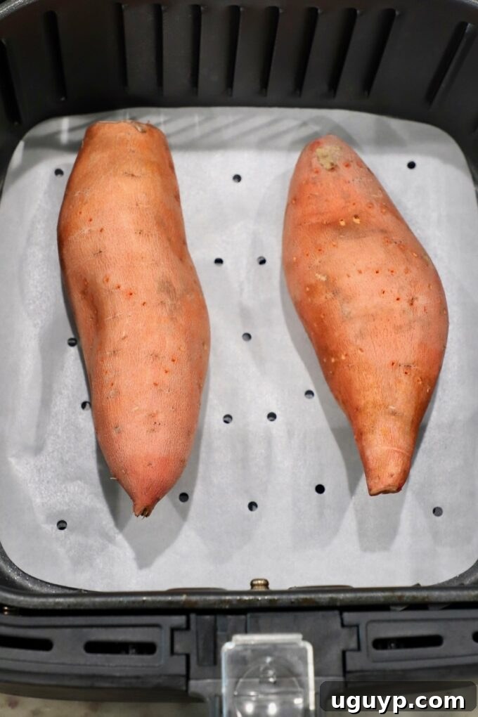 Uncooked sweet potatoes ready for the air fryer basket