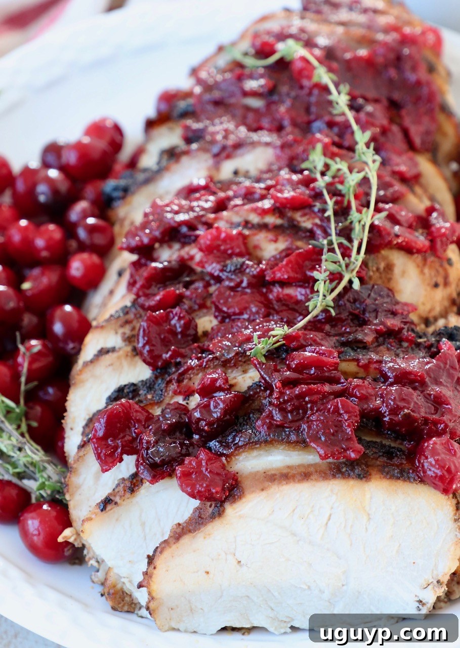 Sliced cranberry glazed turkey breast on a serving plate