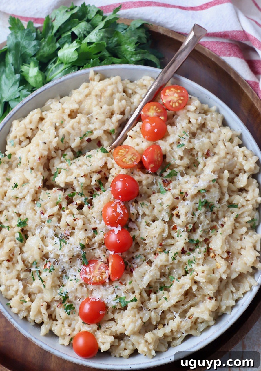 Instant Pot Risotto garnished with halved cherry tomatoes in a white bowl.
