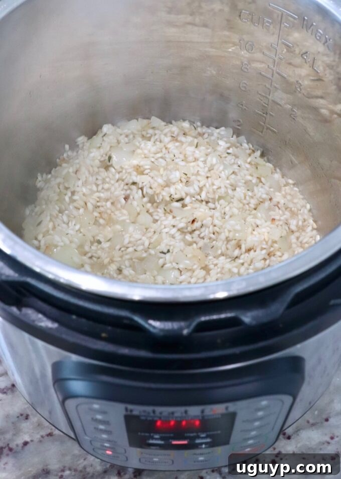 White wine deglazing the Instant Pot with toasted rice and onions.