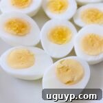 hard boiled eggs cut in half on white plate