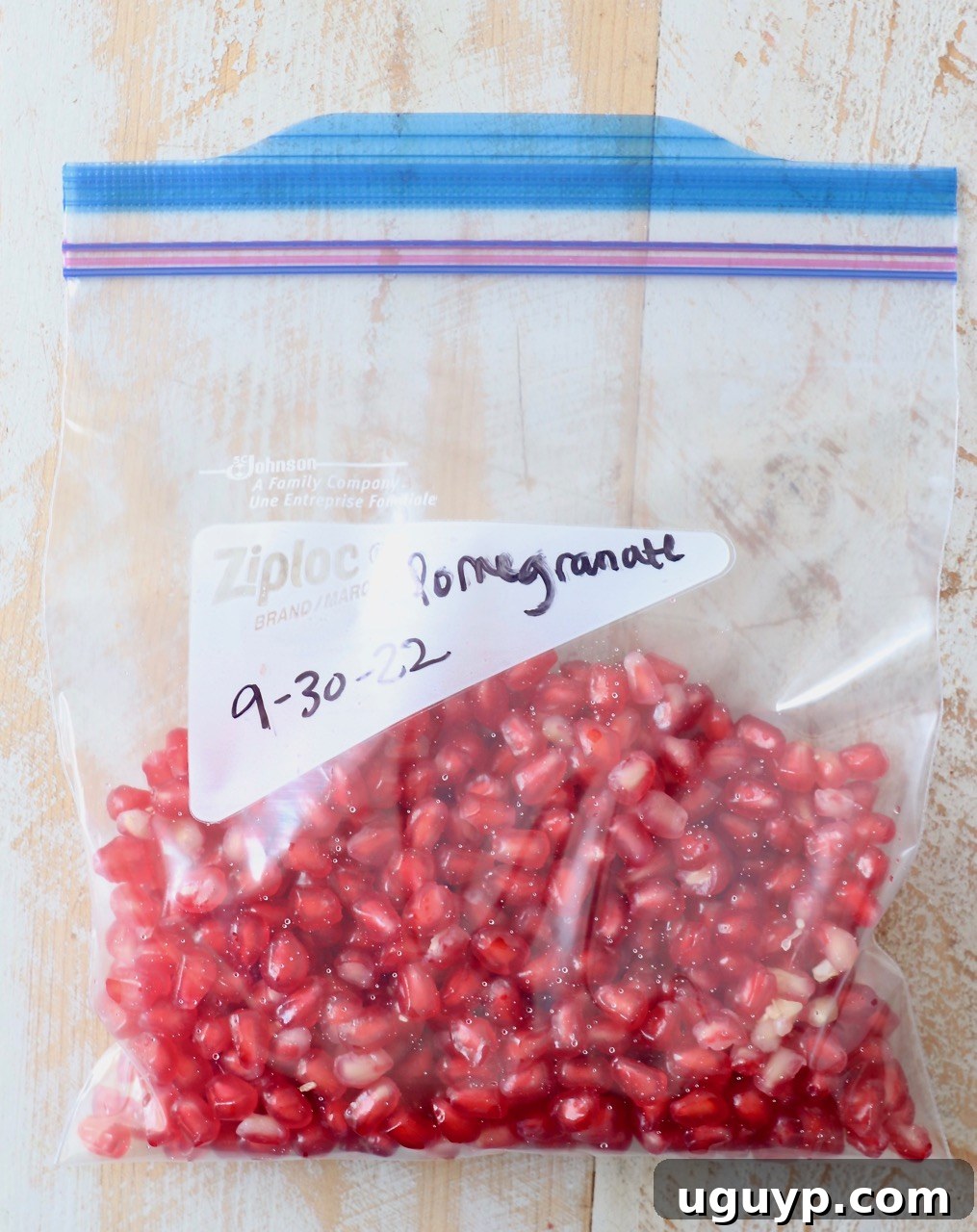 Pomegranate arils stored in a freezer bag.