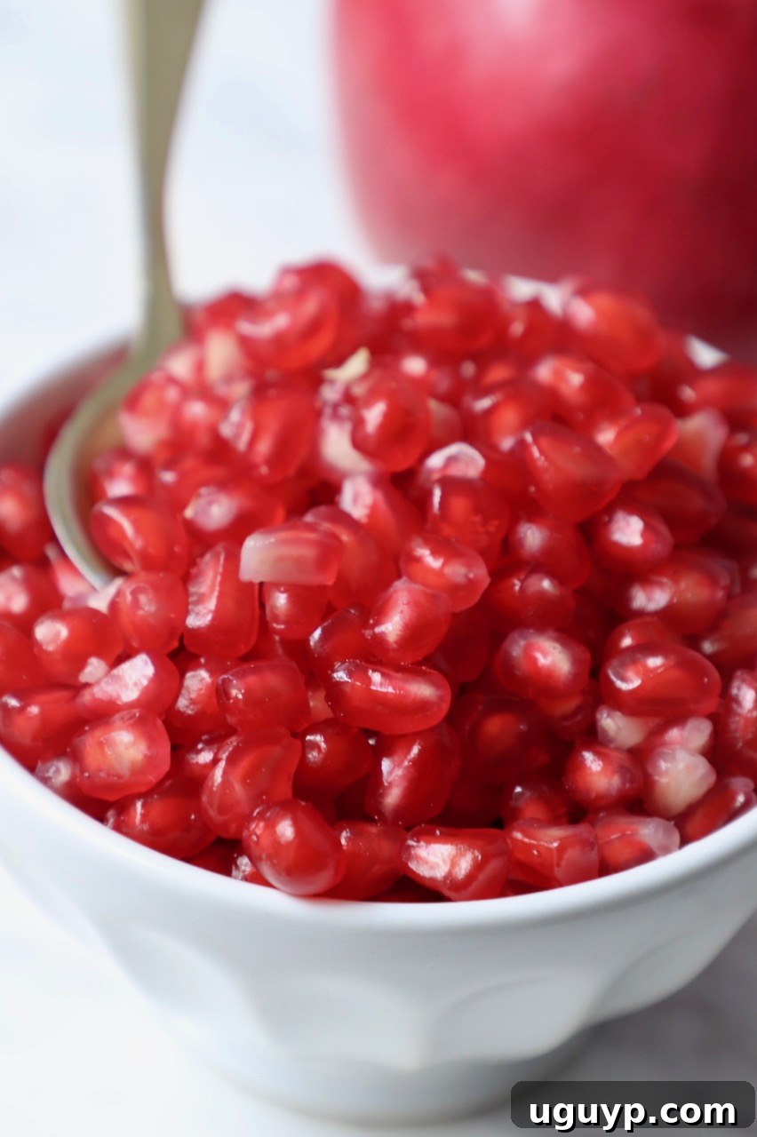 Bowl of glistening pomegranate arils, ready for use.
