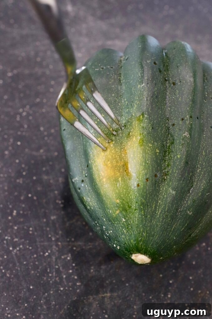 a fork poking holes into a whole acorn squash on a cutting board, preparing it for microwave cooking