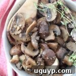 sauteed mushrooms in bowl with wooden spoon