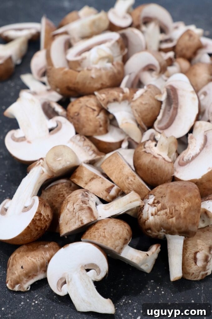 Sliced mushrooms on a cutting board, ready for cooking