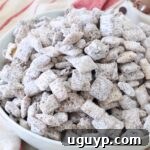 A small bowl of Nutella Muddy Buddies, showcasing the powdery coating.