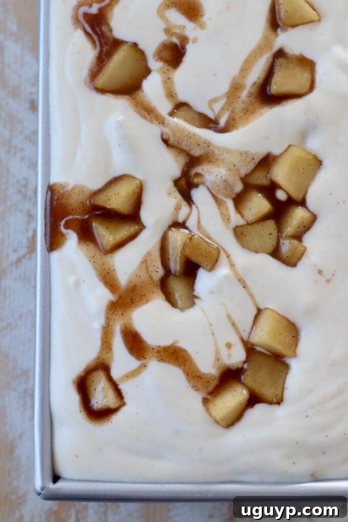 The finished apple pie ice cream mixture poured into a metal container, tightly covered, and ready for freezing.