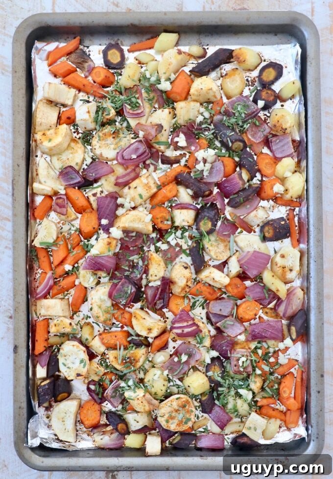 Diced vegetables on baking sheet with fresh chopped rosemary