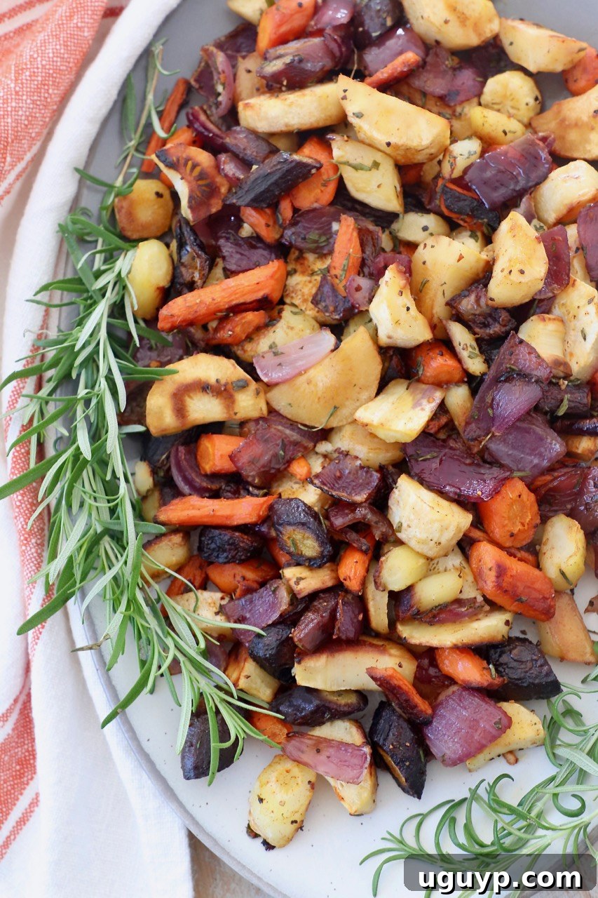 Roasted root vegetables on plate with fresh rosemary sprigs