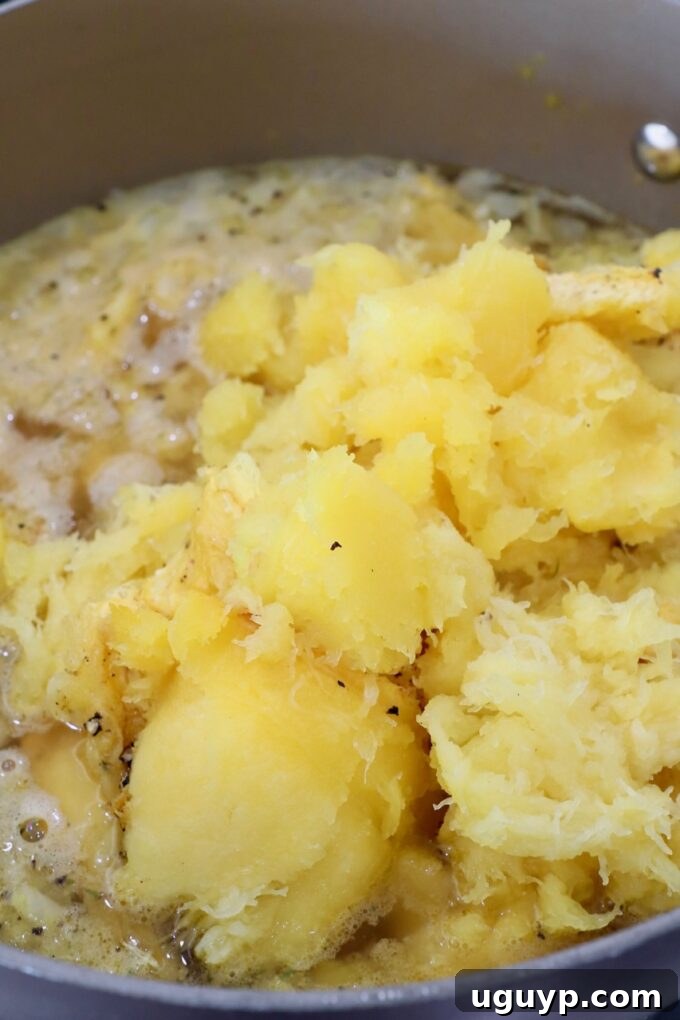 roasted squash in pot with vegetables and broth