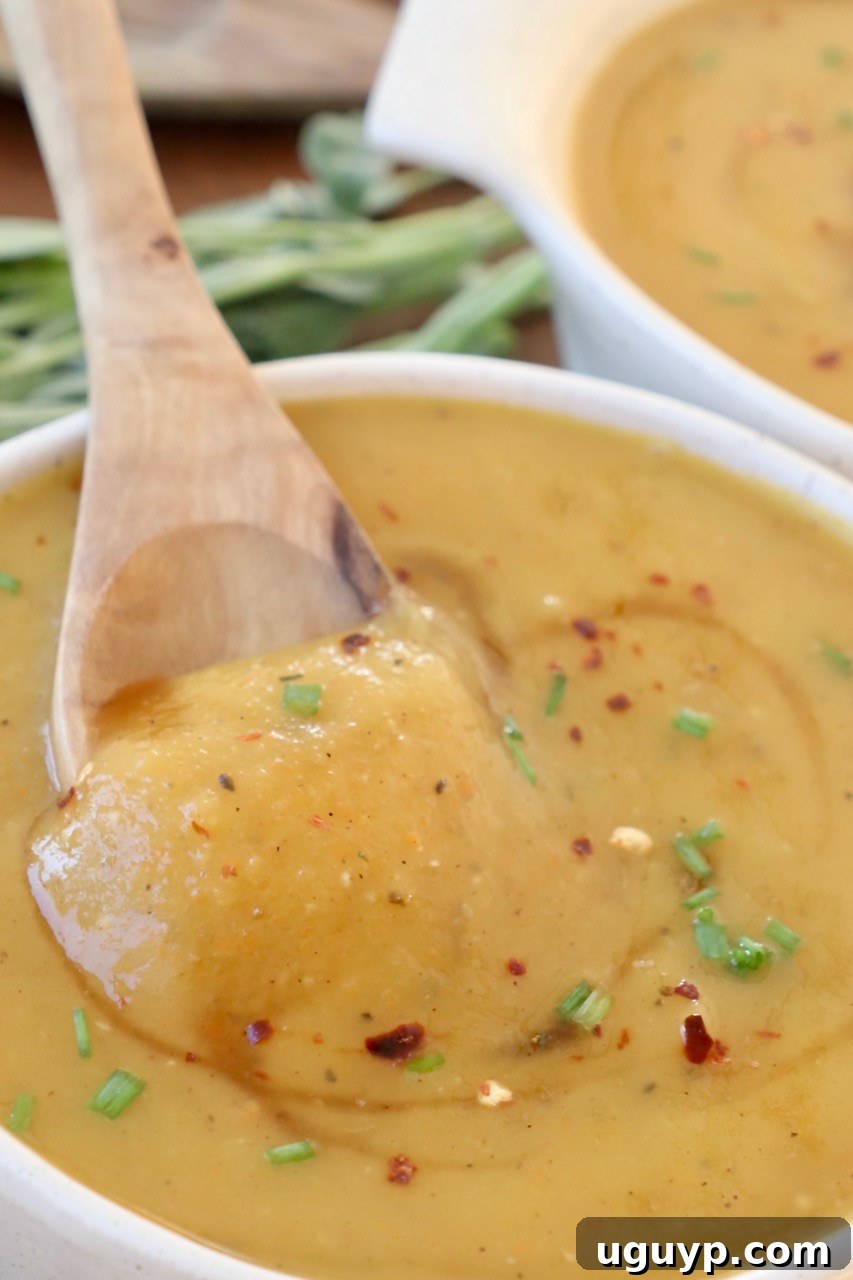 squash soup in bowl with spoon