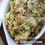 cooked shaved brussels sprouts in white serving dish