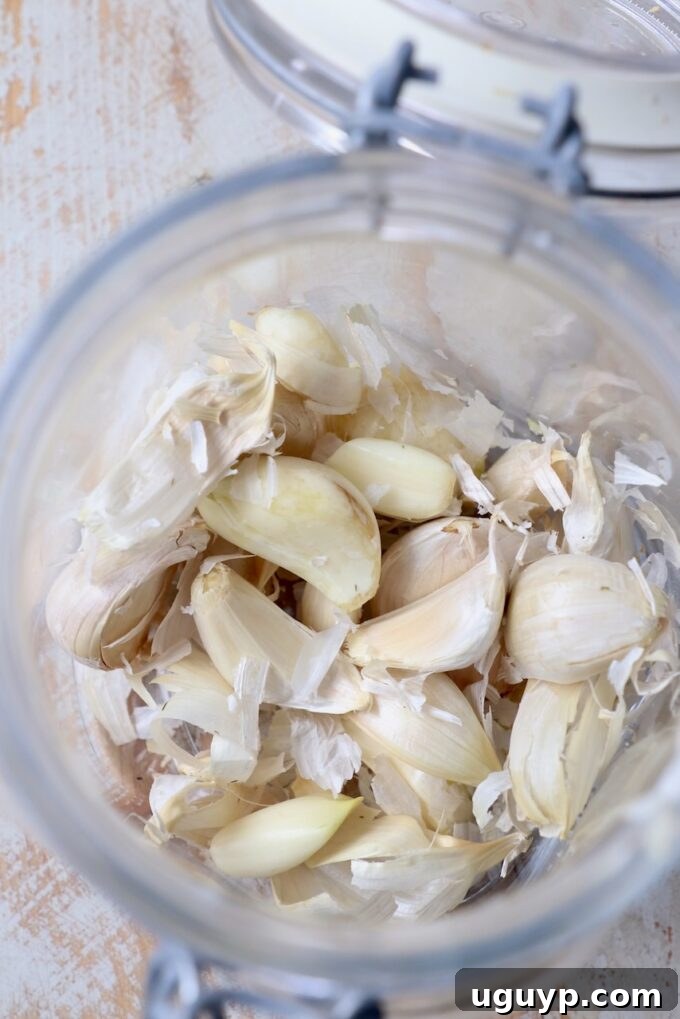 Partially peeled garlic cloves after shaking in a glass jar