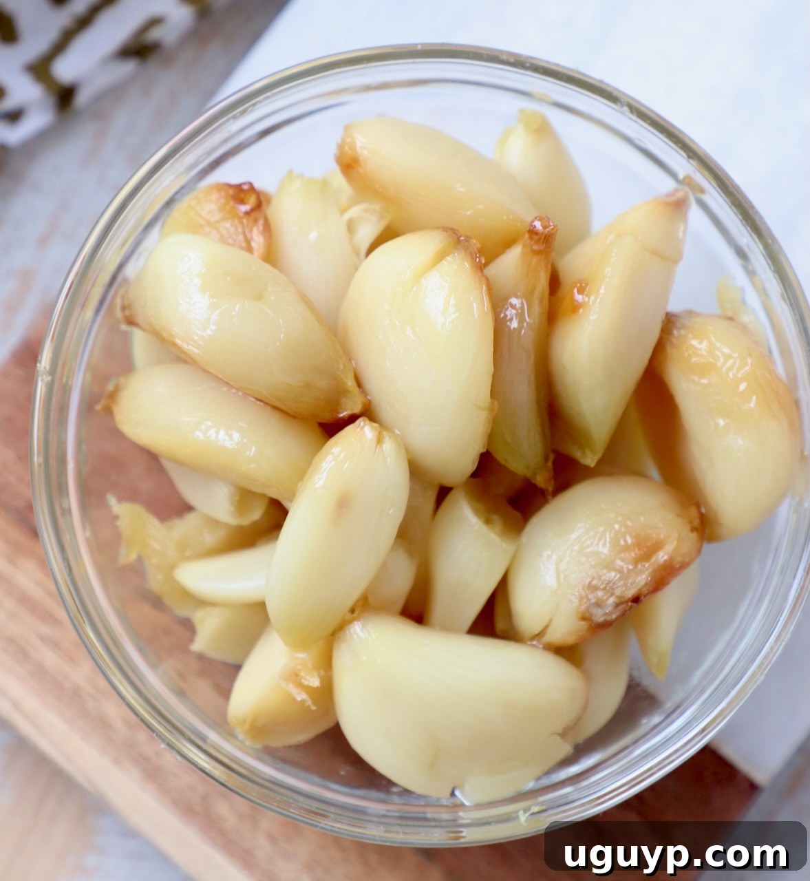 Beautifully roasted garlic cloves in a glass bowl, ready to be enjoyed.