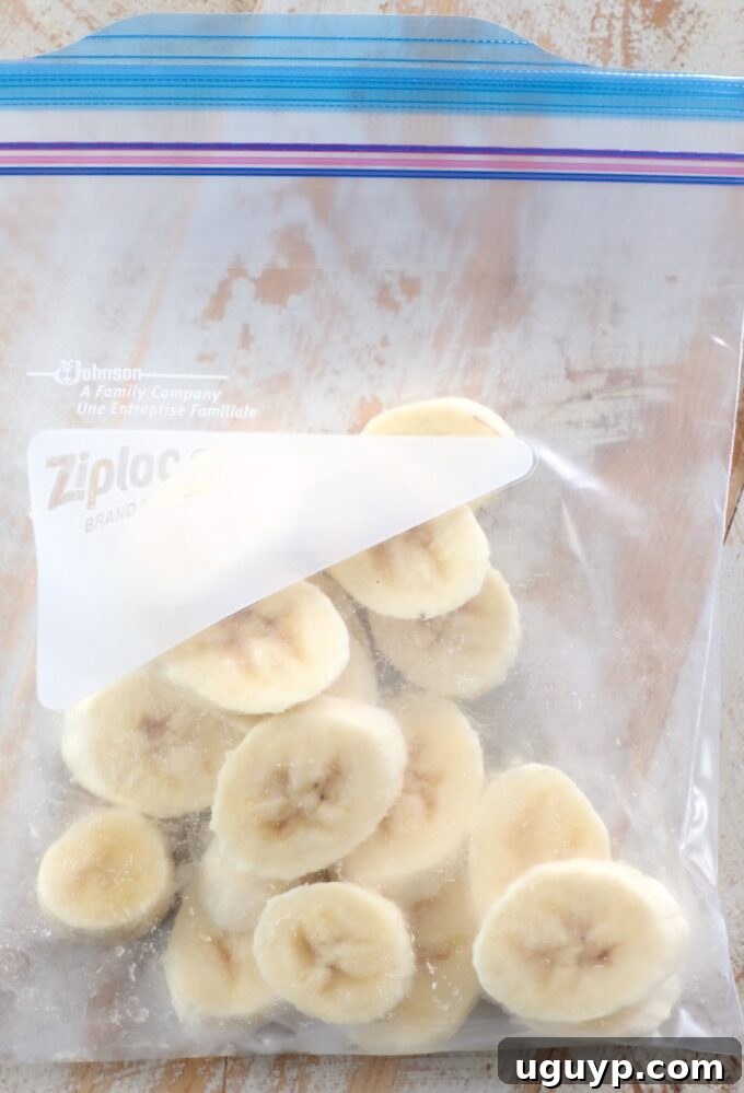 Frozen banana slices stored in a plastic zipper bag for long-term freshness.
