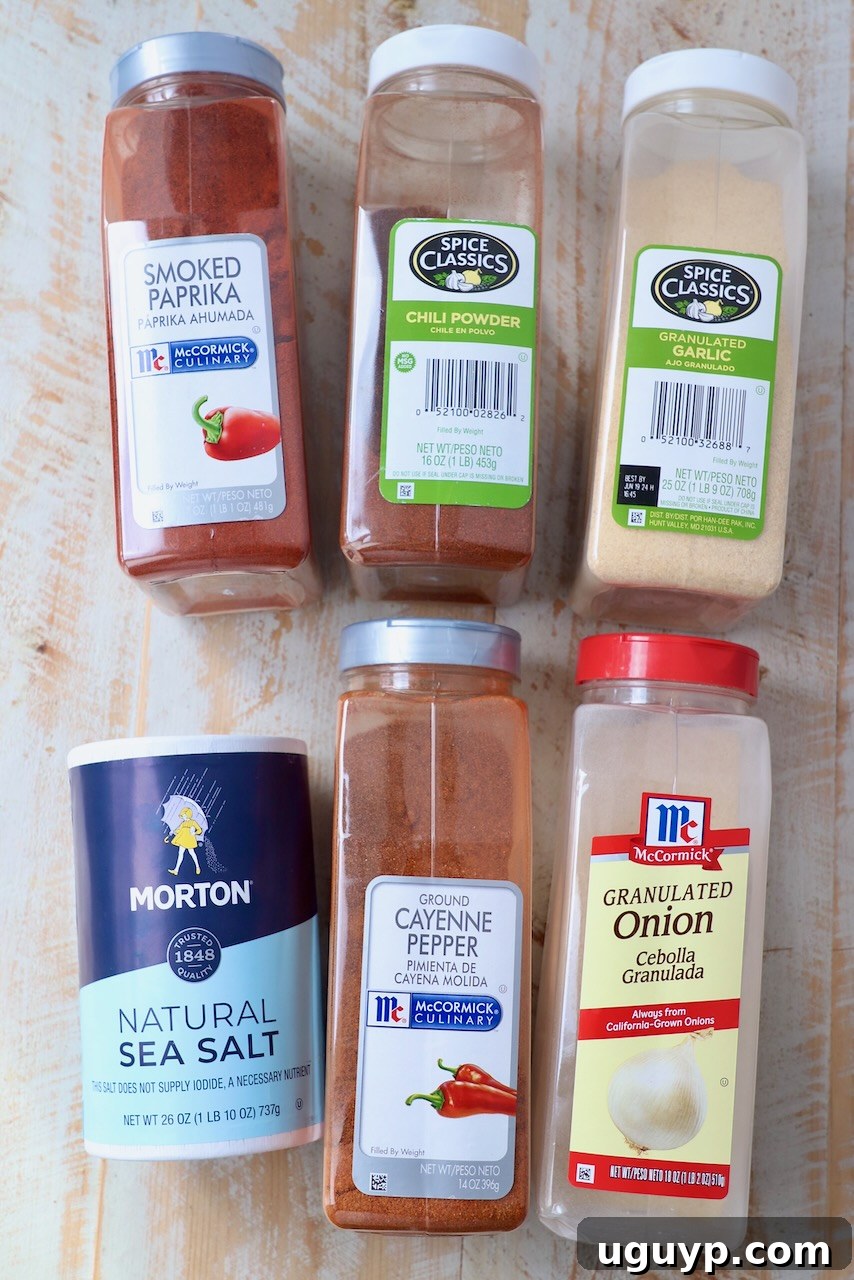 Individual chicken wing seasoning ingredients laid out on a white wooden board, showcasing their vibrant colors and textures.