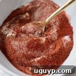 chicken wing seasoning in white bowl with gold spoon