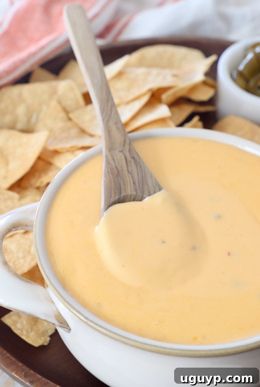 nacho cheese sauce in bowl with spoon, ready to be served