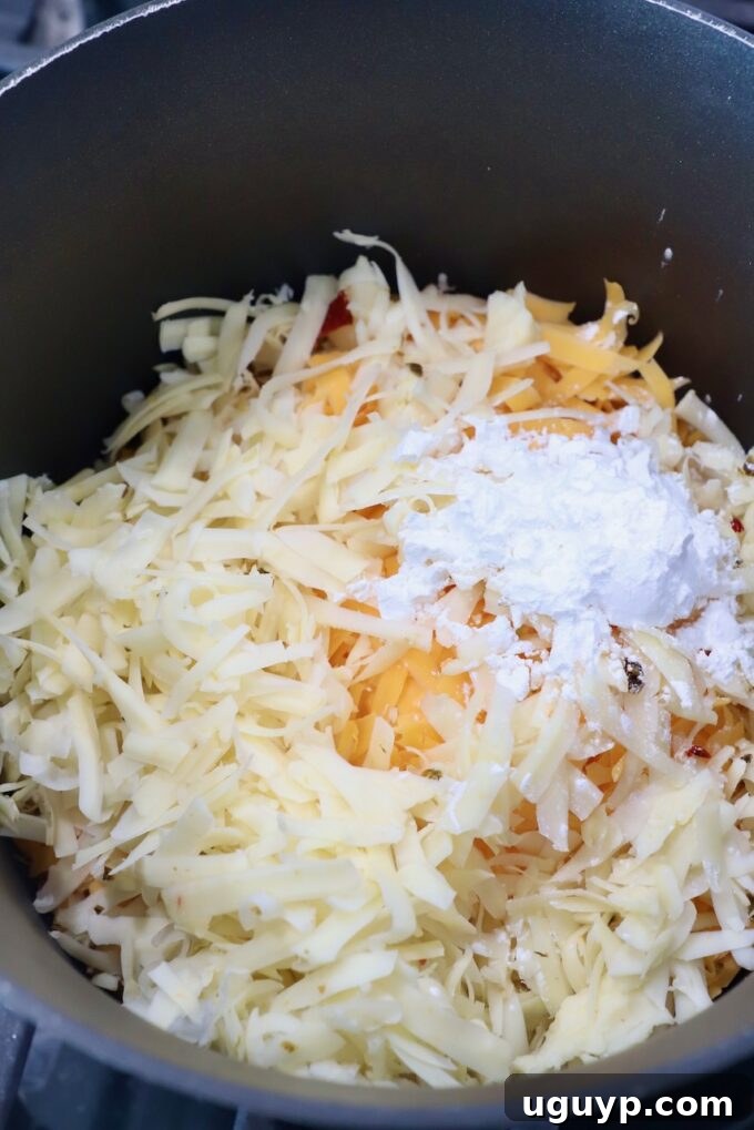 shredded cheese in sauce pot with cornstarch