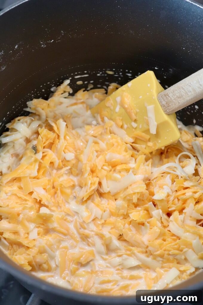 shredded cheese in pan with spatula