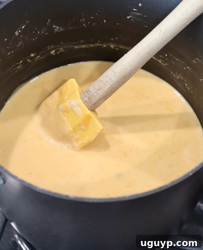 cheese sauce in pan with spatula