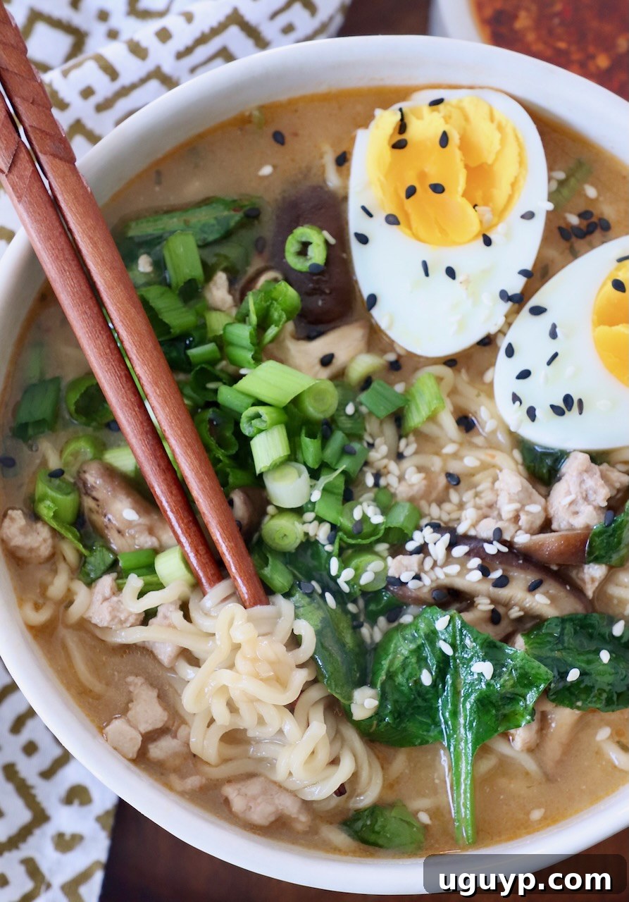 A comforting bowl of Miso Ramen with a perfectly soft-boiled egg, ready to be enjoyed with chopsticks.