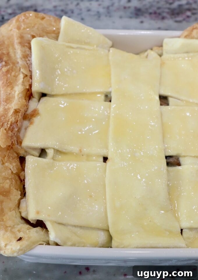 puff pastry crust woven on top of pot pie in a square dish