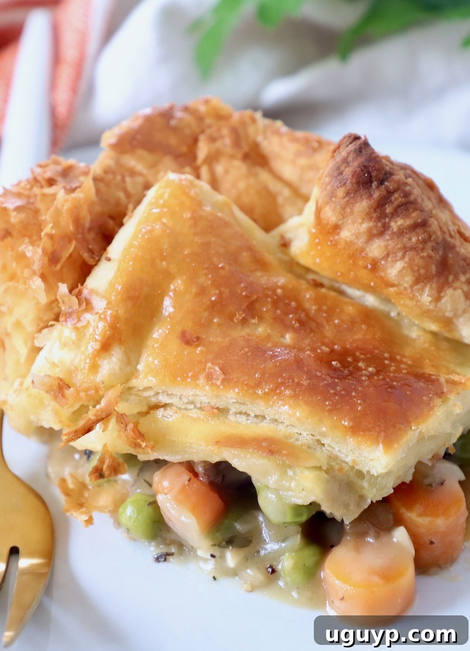 piece of vegetable pot pie on white plate with fork