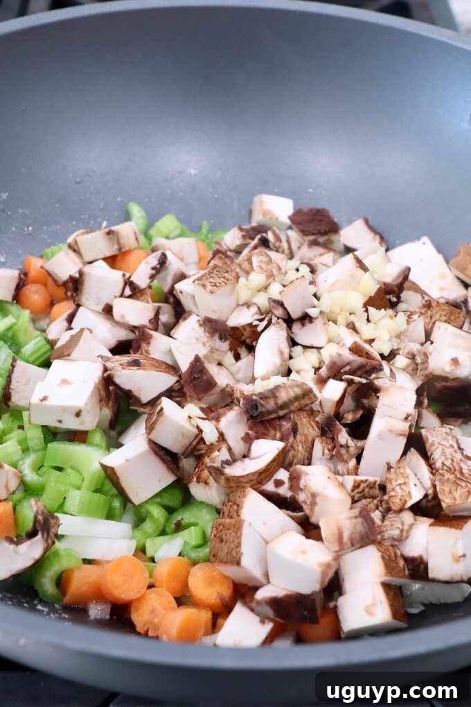 diced mushrooms in pan with onions, carrots and celery