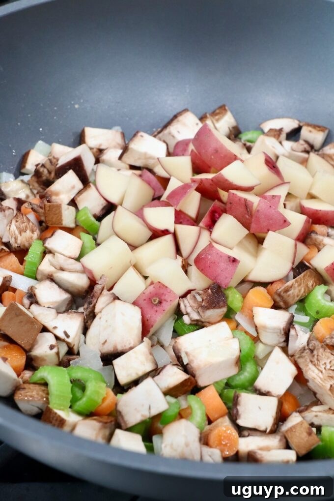 diced potatoes in pan with other diced vegetables