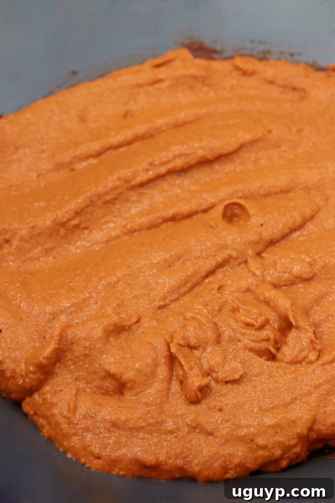 The blended, smooth curry sauce returned to a large pan on the stove, simmering gently and thickening.