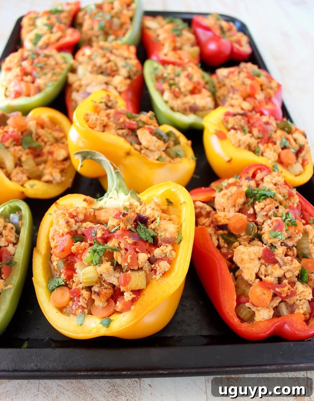 Colorful bell peppers generously stuffed with a healthy mixture of ground chicken, spices, vegetables, and buffalo sauce.