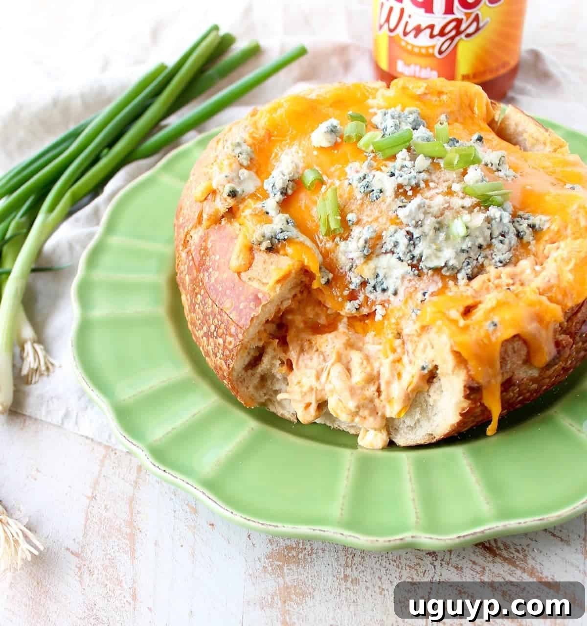 Everyone's favorite buffalo chicken dip baked directly into a rustic bread bowl, perfect for sharing.