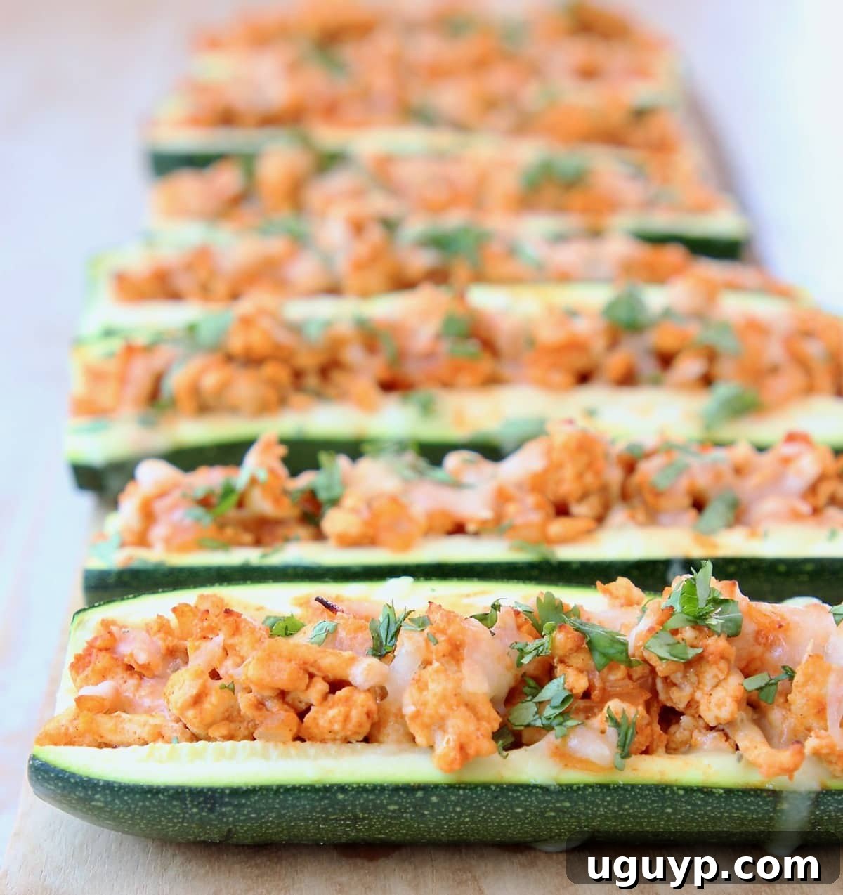Delicious Buffalo Chicken Zucchini Boats topped with melted pepper jack cheese and fresh cilantro.