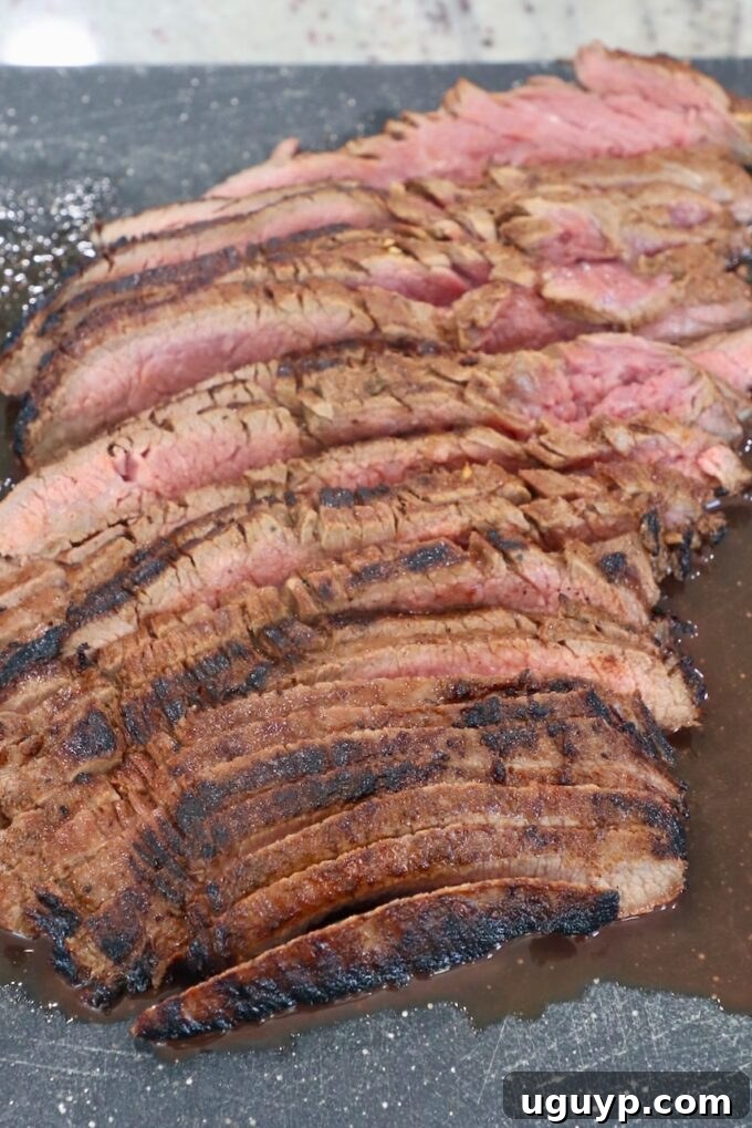 thinly sliced grilled steak on cutting board