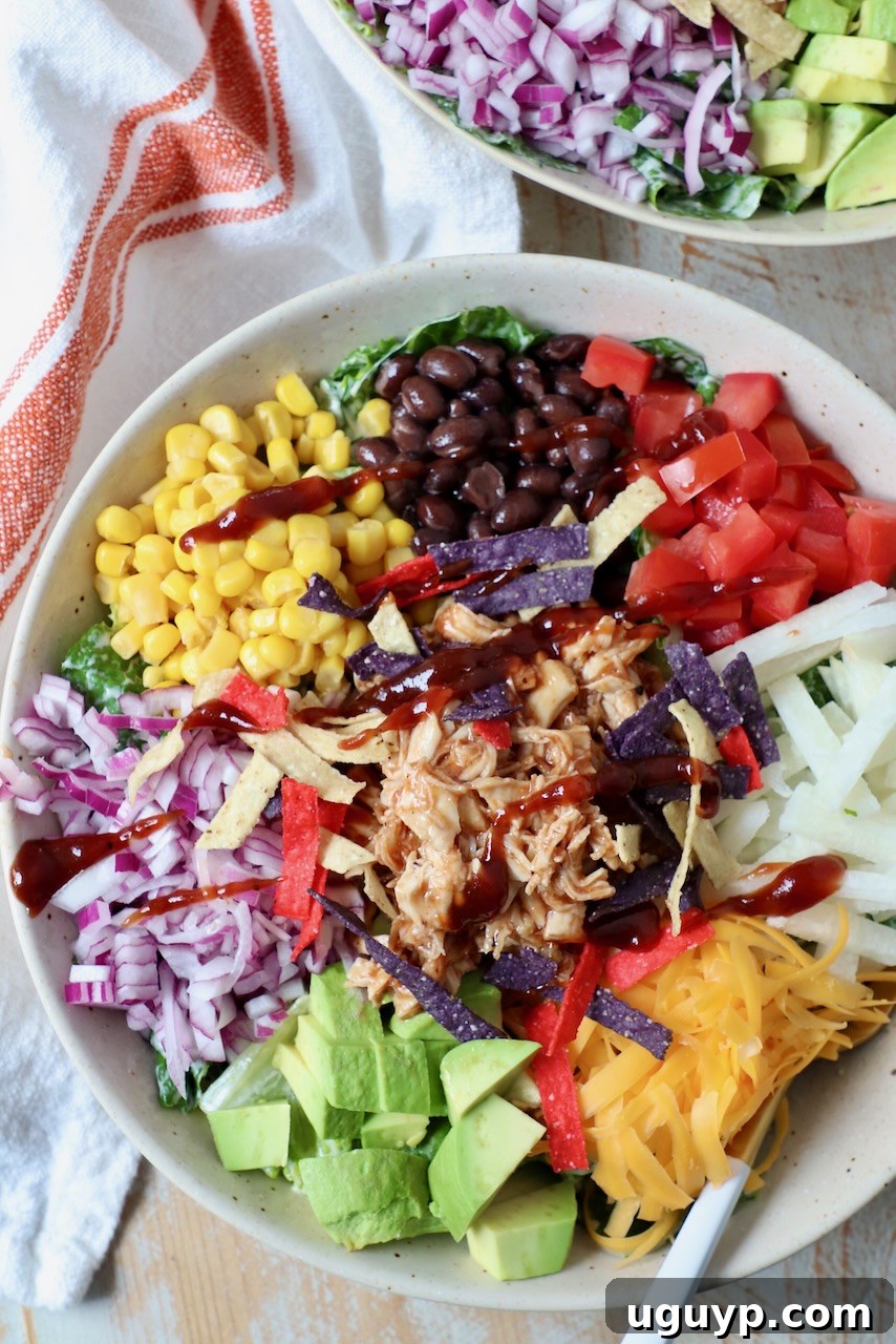 A vibrant BBQ Chicken Salad in a bowl, showcasing all the fresh, colorful ingredients.