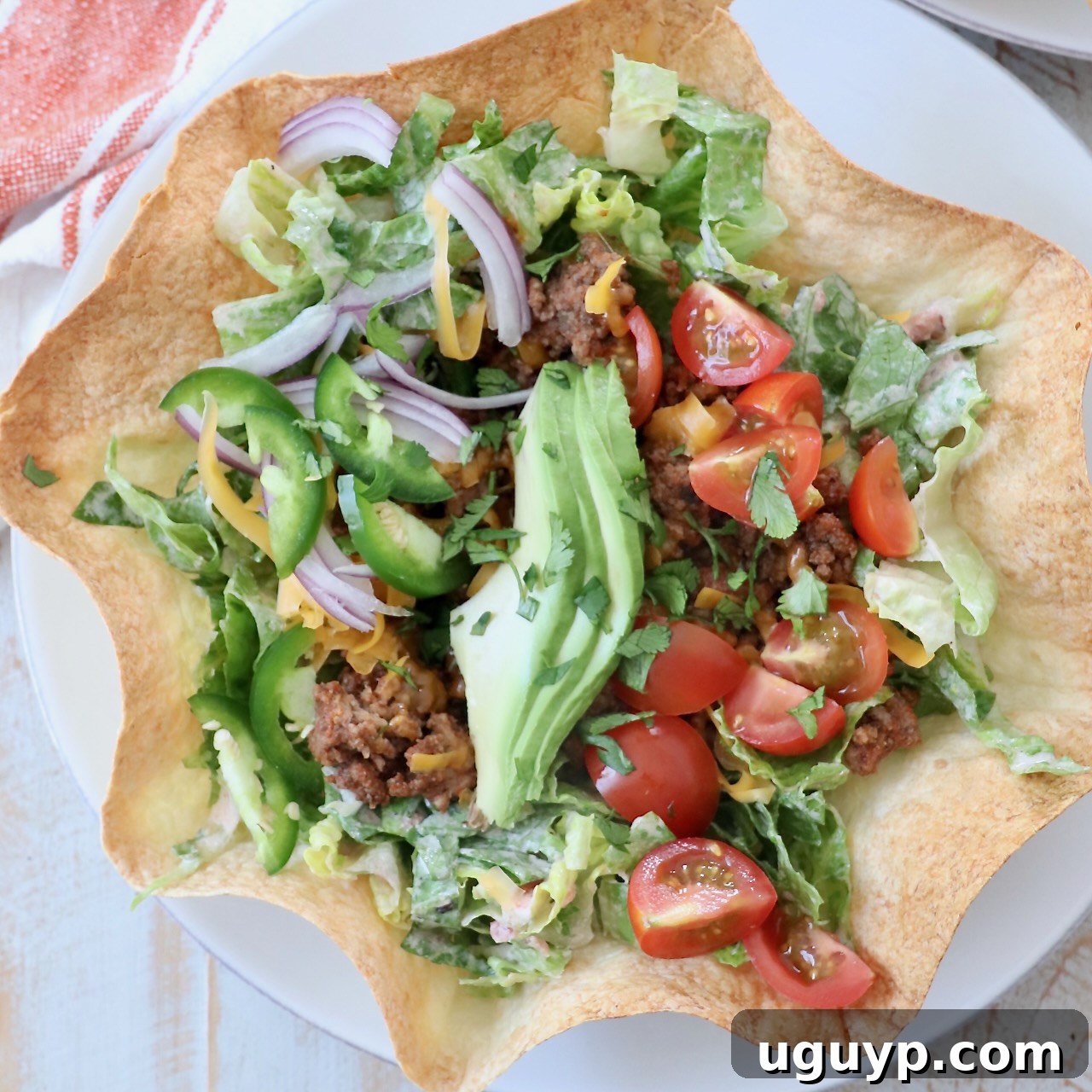 taco salad in tortilla shell on plate