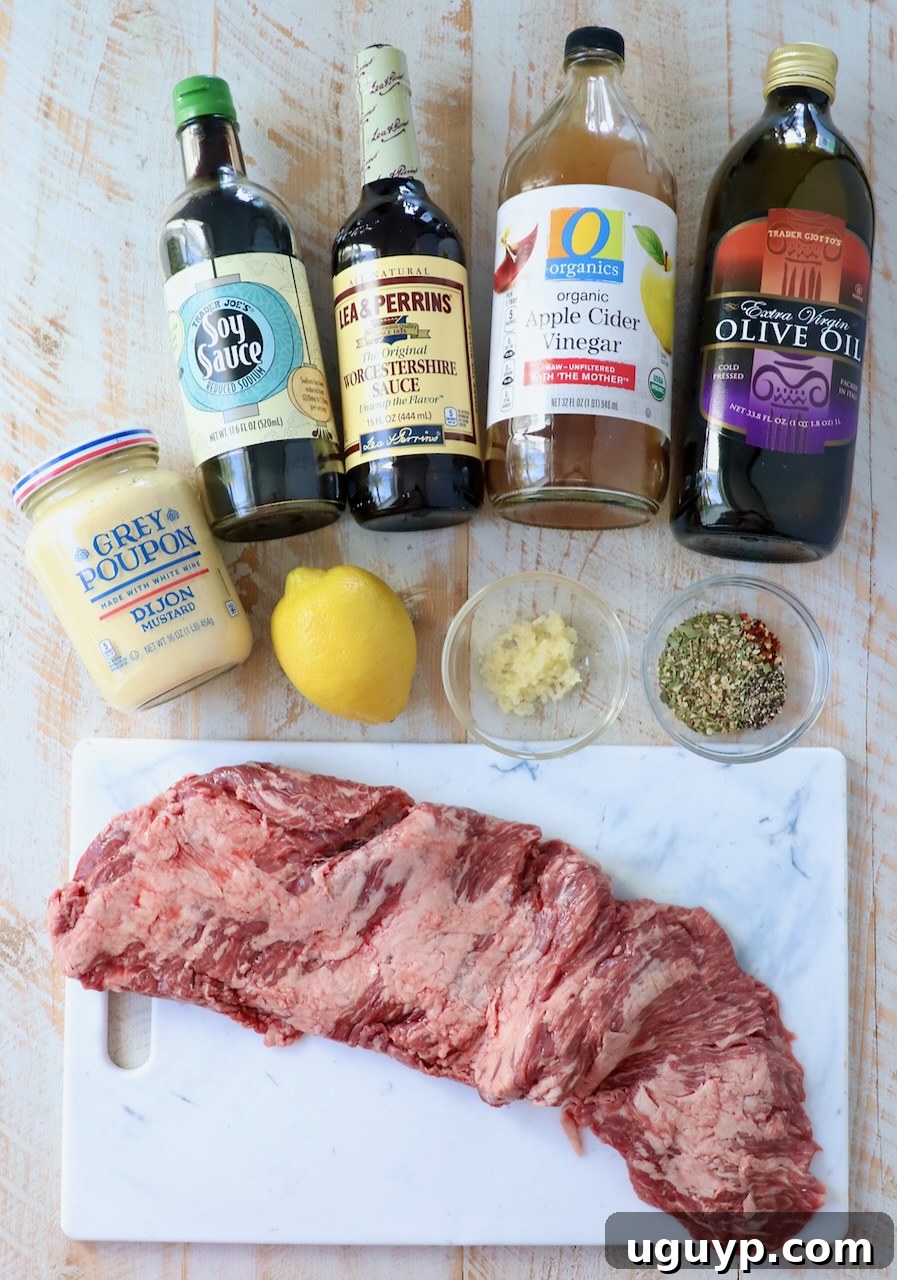 Ingredients for homemade skirt steak marinade laid out on a white wooden board