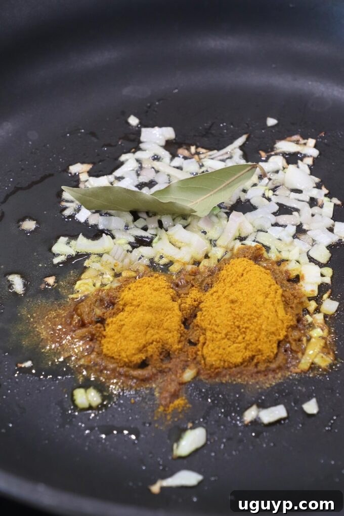 curry powder, diced shallots and bay leaf in a skilelt