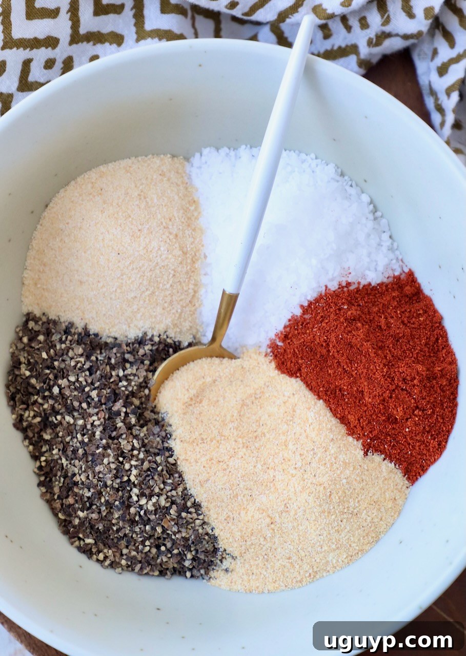 Various coarse spices separated in bowls, ready to be mixed for a pulled pork rub recipe.