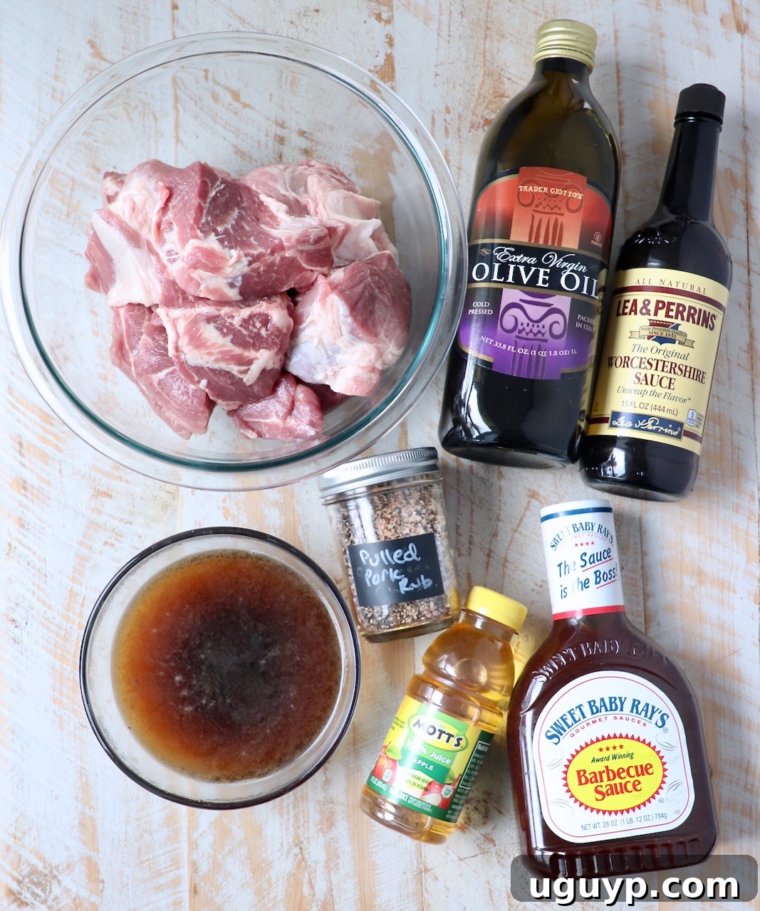 Ingredients for Instant Pot Pulled Pork laid out on a white wooden board