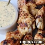 grilled chicken wings on plate with a small bowl of garlic parmesan sauce on the side