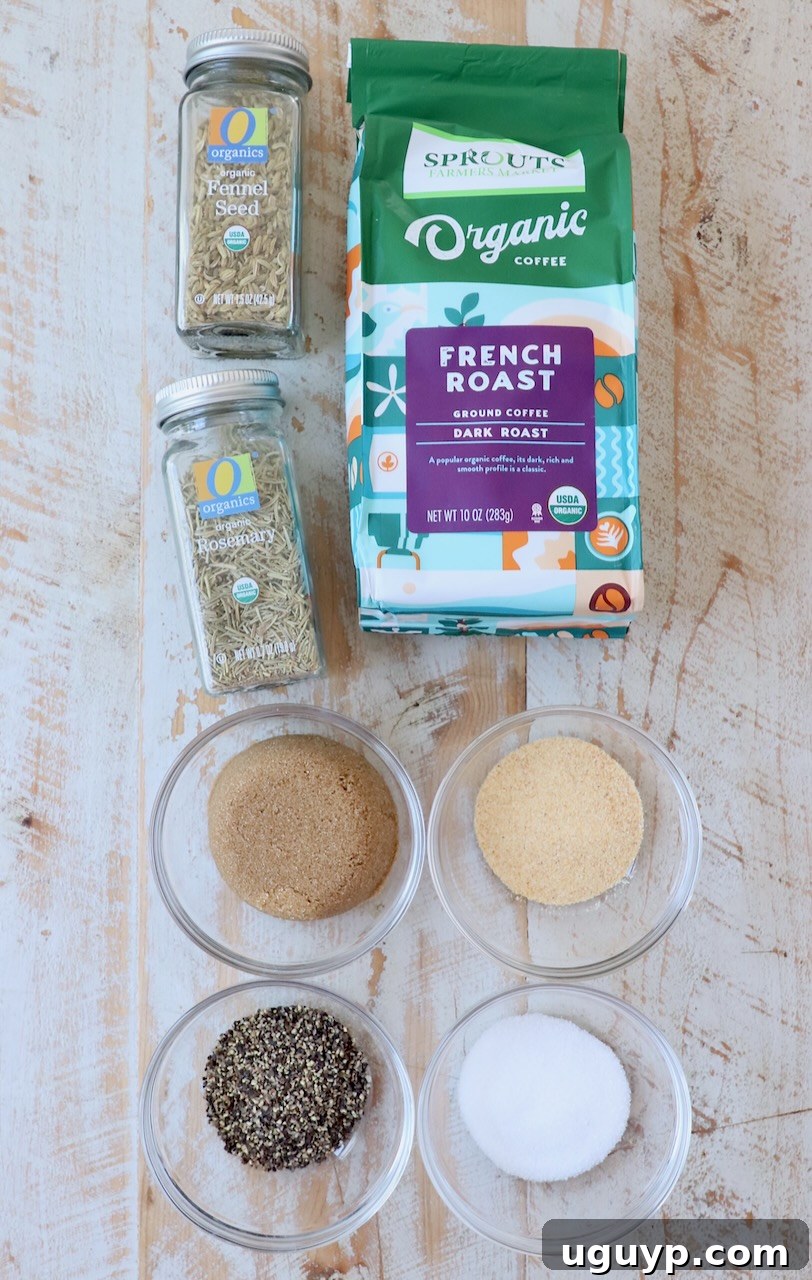 Various ingredients for the coffee steak rub, including ground coffee, brown sugar, and an assortment of dried herbs and spices, are neatly arranged on a rustic white wooden board, ready for mixing.