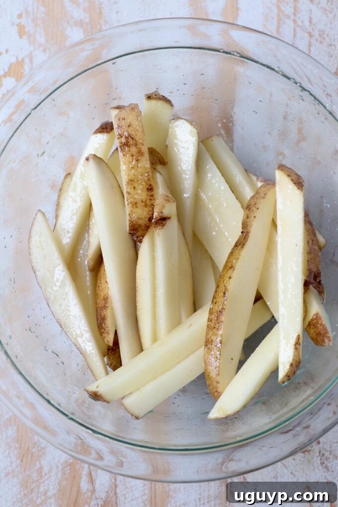 uncooked fries in glass bowl