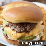 smash burger on plate with fries