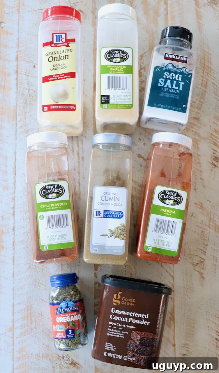 Various individual spices and herbs stored in plastic containers, ready for measuring and mixing into the perfect enchilada seasoning blend